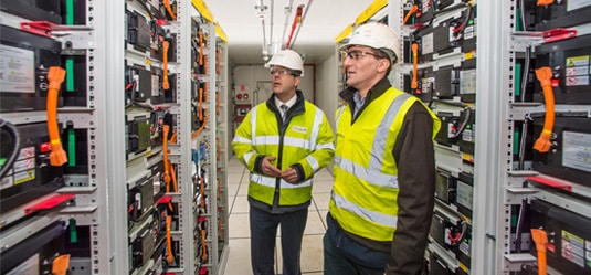 Two utilty workers examining electrical equipment