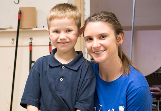 A PPL employee volunteer and child smiling