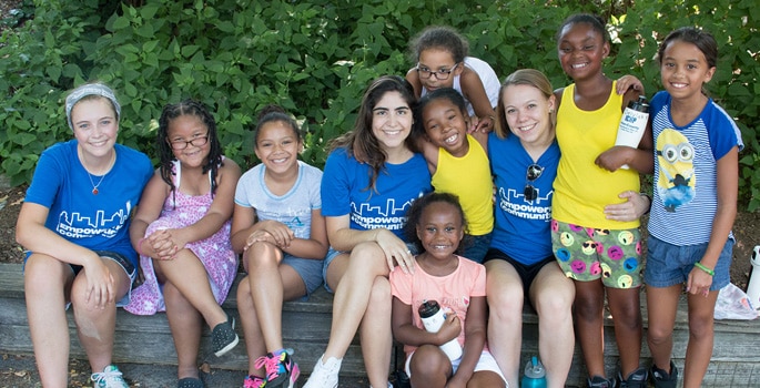 A diverse group of smiling students and PPL employee volunteers