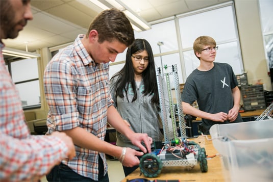 A group of students building a robot