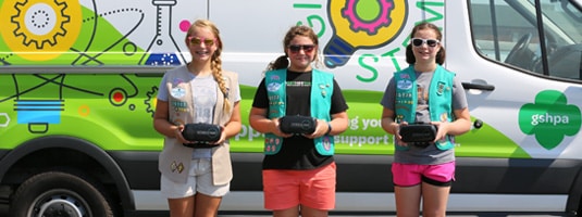 Three Girl Scouts using virtual reality equipment