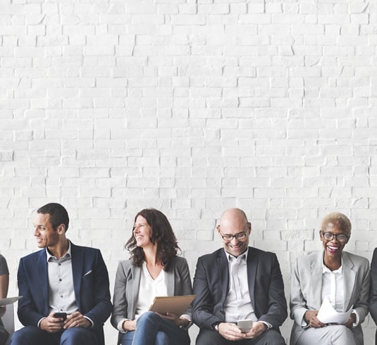 A group of diverse men and women sitting together