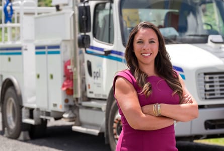 A female PPL employee standing in front of a utility truck