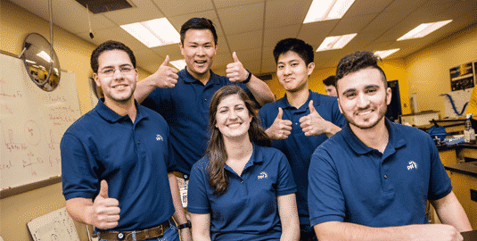 A group of diverse employees holding their thumbs up