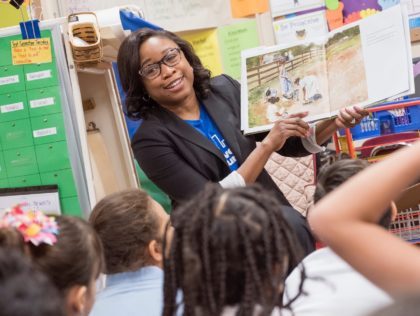 Woman reads to elementary school students
