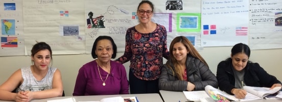 Nancy Hamlin (standing), a volunteer classroom assistant at The Literacy Center in Allentown, helps students enrolled in the organization’s English as a Second Language class.