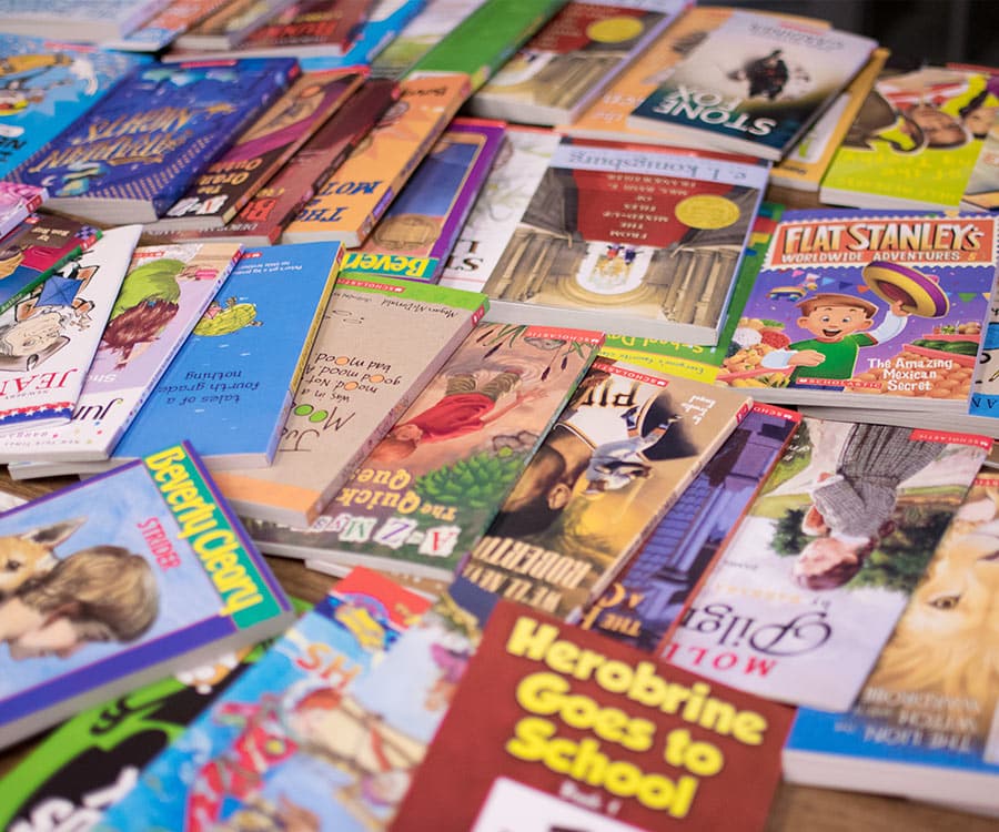 Colorful pile of children's books laying on table