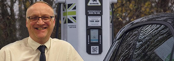 WPD Engineer Mark Dale poses with electric vehicle