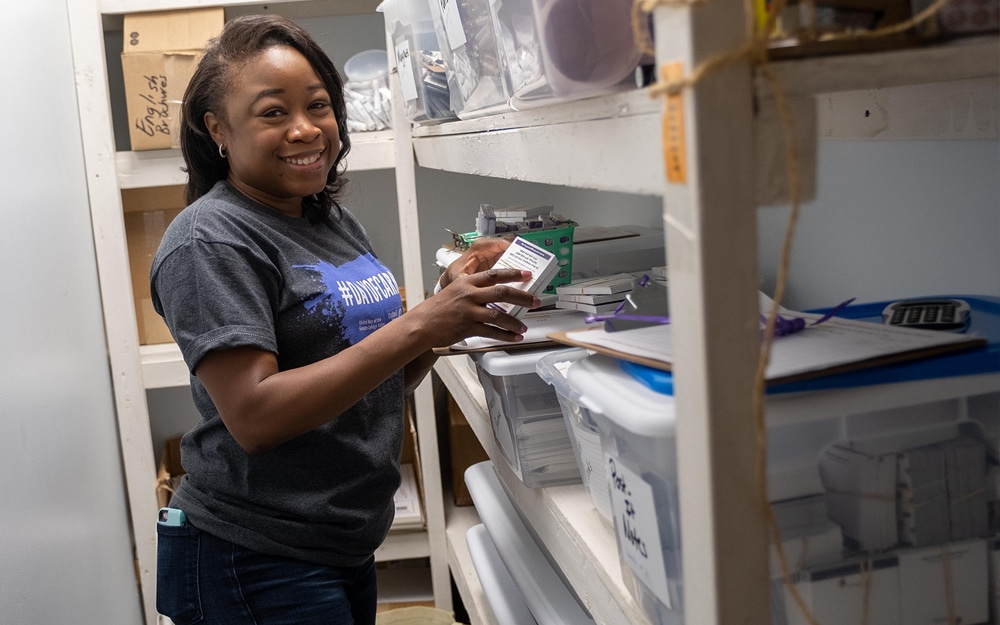 PPL female volunteer organizes shelves at a non-profit organization