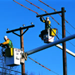 Lineman work on power lines in the 2000s