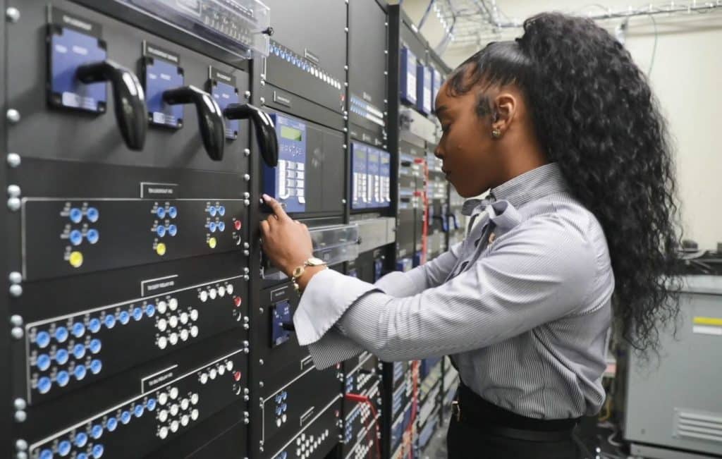 Female engineer works in a computer room.