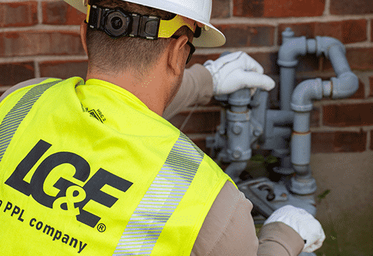 LG&E employee working on pipes