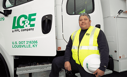 LG&E employee poses next to truck