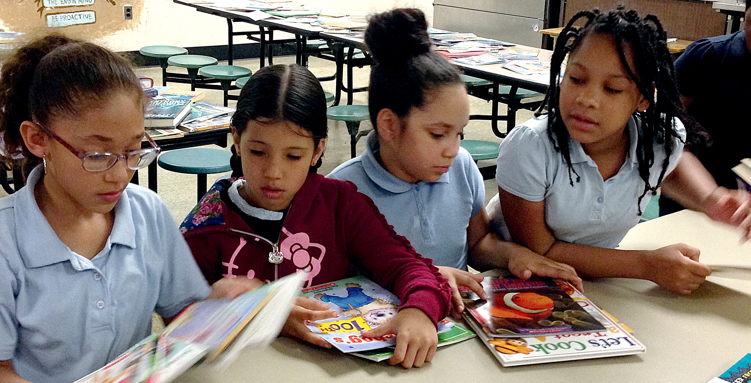 Girls at school reading books together