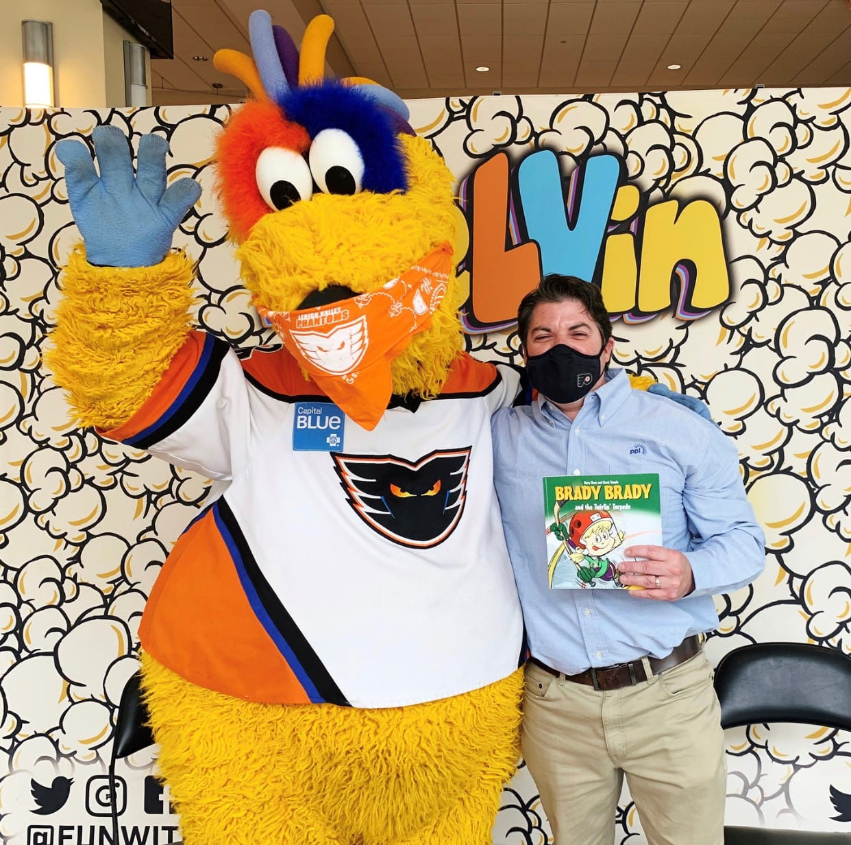 Picture of meLVin the Lehigh Valley Phantoms mascot and Kevin Amerman posing with a book