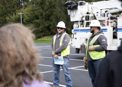 Photo of linemen talking to parents and kids